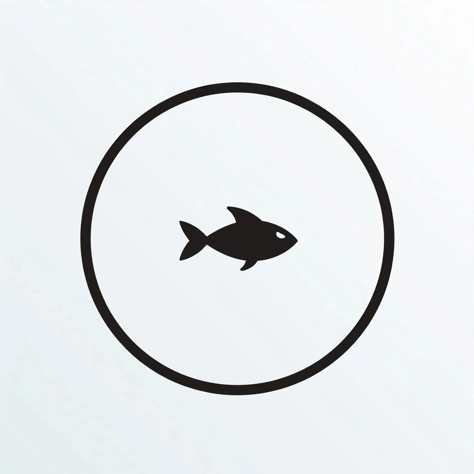 A tiny black fish in a fishbowl